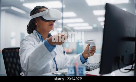 Futuristic Medical Hospital: Black Female Neurosurgeon Wearing Virtual Reality Headset Uses Controllers to Remotely Operate Patient Using Medical Robot. High-Tech Treatment of Neurological Disease Stock Photo
