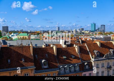 Panoramic view of city skyline with traditional low-rise roof-tiled houses and modern skyscrapers under a blue sky with clouds, Warsaw, Poland, Europe Stock Photo