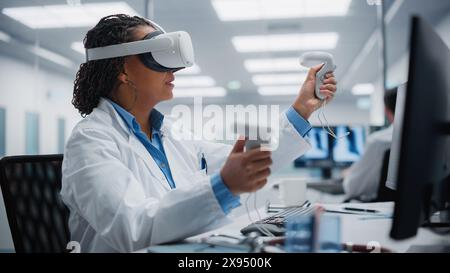 Futuristic Medical Hospital: Neurosurgeon Wearing Virtual Reality Headset Uses Controllers to Remotely Operate Patient with Medical Robot. Modern High-Tech Advance in Breakthrough Medical Treatment Stock Photo