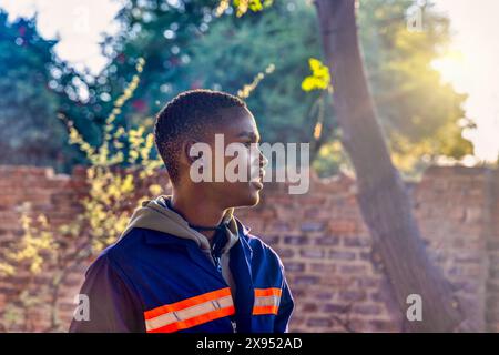 portrait of a single african american man wearing workwear outdoors at sunset Stock Photo