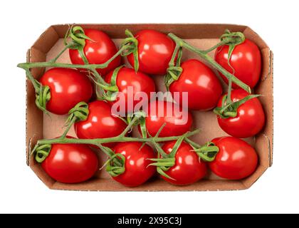 Grape tomatoes on the vine in a cardboard punnet. Ripe, small, oblong, red cocktail tomatoes in the size of a thumb tip, shaped like a plum tomato. Stock Photo