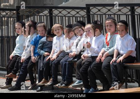 Orthodox Jewish children wait for the start of Lag B'Omer festivities outdoors in Brooklyn, New York, 2024. Stock Photo