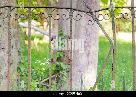 old rusted wrought iron gate with the letter H Stock Photo