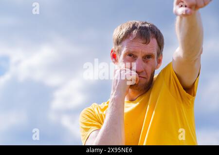 Man Practicing Boxing Moves in Scenic Park on a Sunny Afternoon. Stock Photo