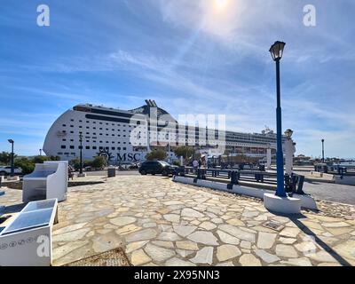 Mykonos, Greece - 7 May 2024: Cruise theme picture, vacationers walk back to the cruise ship MSC Lirica in the port of Mykonos in Greece *** Kreuzfahrt Themenbild, Urlauber laufen zurück auf das Kreuzfahrtschiff MSC Lirica im Hafen von Mykonos in Griechenland Stock Photo