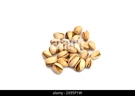 On a white background lies a mountain of pistachios ready to eat. Stock Photo