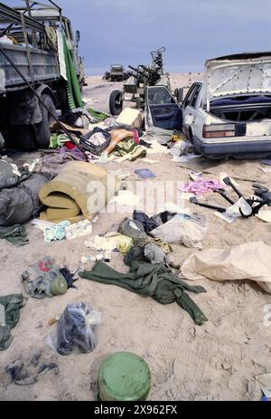 5th March 1991 Personal belongings lie scattered among wrecked and burnt-out military vehicles, part of an Iraqi convoy that was attacked with cluster bombs by the USAF about a week before on Route 801, the road to Um Qasr, north of Kuwait City. Stock Photo