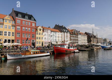 General view of Nyhavn, a popular tourist spot known for its colorful historic houses, bars, and restaurants, and boats. Copenhagen ranks fourth in the world in the Mercer 2023 Quality of Living Survey. A stable economy, excellent education services, and high social safety make it attractive for locals and tourists. Copenhagen is also one of the world's most expensive cities and a popular tourist destination. Stock Photo