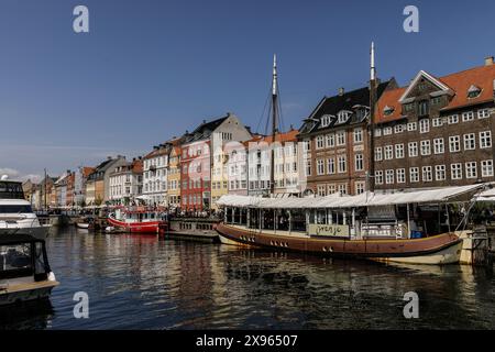 Copenhagen, Denmark. 25th May, 2024. General view of Nyhavn, a popular tourist spot known for its colorful historic houses, bars, and restaurants, and boats. Copenhagen ranks fourth in the world in the Mercer 2023 Quality of Living Survey. A stable economy, excellent education services, and high social safety make it attractive for locals and tourists. Copenhagen is also one of the world's most expensive cities and a popular tourist destination. (Photo by Volha Shukaila/SOPA Images/Sipa USA) Credit: Sipa USA/Alamy Live News Stock Photo