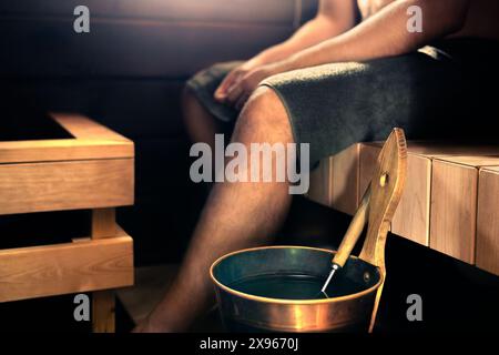 Sauna and man in Finland. Steam spa at home or wood cabin. Guy in hot interior health room in summer. Wellness and rest. Finnish people lifestyle. Stock Photo