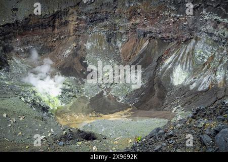 Sulphurous fumaroles and volcanic strata in Tompaluan active crater on the flank of Mount Lokon, a volcano near Tomohon city, Gunung Lokon, Indonesia Stock Photo