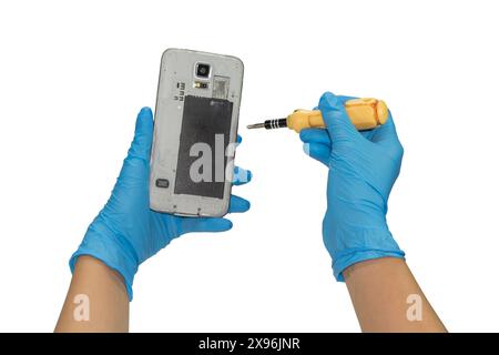 Gloved hand holding a smart phone. To make repairs. Stock Photo