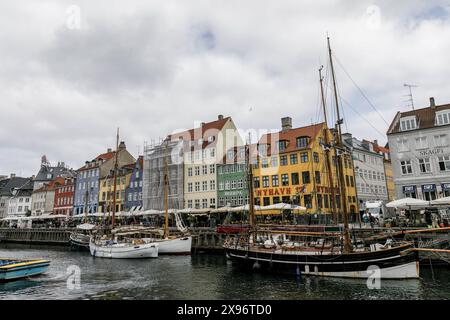 Copenhagen, Denmark. 24th May, 2024. General view of Nyhavn, a popular tourist spot known for its colorful historic houses, bars, and restaurants, and boats. Copenhagen ranks fourth in the world in the Mercer 2023 Quality of Living Survey. A stable economy, excellent education services, and high social safety make it attractive for locals and tourists. Copenhagen is also one of the world's most expensive cities and a popular tourist destination. (Credit Image: © Volha Shukaila/SOPA Images via ZUMA Press Wire) EDITORIAL USAGE ONLY! Not for Commercial USAGE! Stock Photo