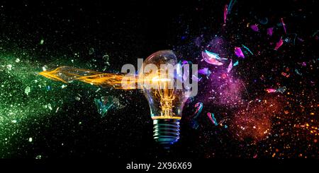 Creative  light bulb shattering colorful sparks adark backdrop Stock Photo