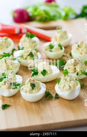 stuffed eggs, deviled eggs on a wooden table . Stock Photo