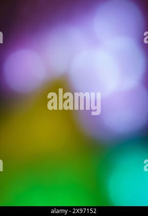 Multicoloured abstract background in purple, yellow, aqua and green with defocused light blur circles for spring summer Christmas holiday backdrop Stock Photo