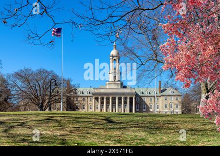 The Old Main building and spring flowers on the campus of Penn State University Stock Photo