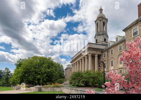 The Old Main building and spring flowers on the campus of Penn State University Stock Photo