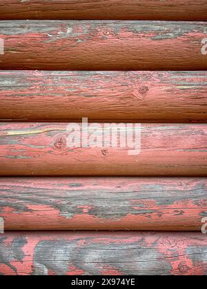Background Image of Distressed Cabin Logs Painted Red and Weathered Perfect for a Slide Show Background Stock Photo