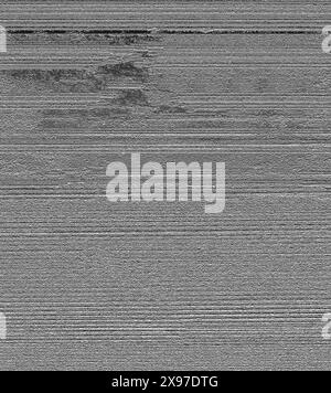 An abstract image featuring glitch art with horizontal lines and digital noise in grayscale, creating a textured and distorted effect Stock Photo