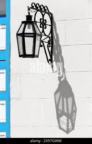 333 Artistic sconce on the exterior wall of the Museo de Arte Colonial Museum casting its shadow on the facade of the building. Sancti Spiritus-Cuba. Stock Photo