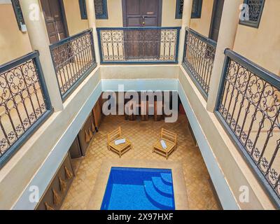 Interior of a typical Moroccan riad with a small pool in the middle of ...