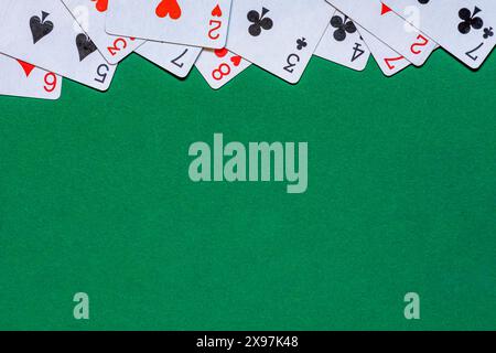 Playing cards on green felt casino table. Background with copy space Stock Photo