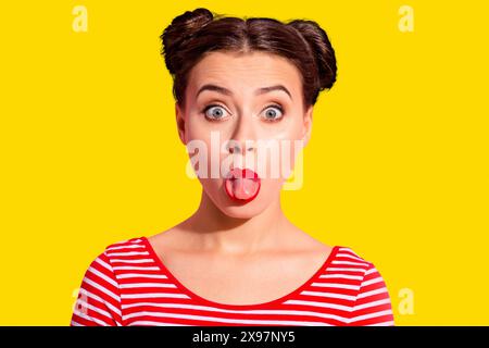 Close up photo beautiful she her lady pretty hairdo two buns bright pomade allure big lips tongue out mouth impolite making faces wear casual striped Stock Photo