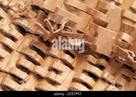 Close-up of intricately cut cardboard showing abstract patterns and textures. The detailed view highlights the layered structure and geometric design Stock Photo