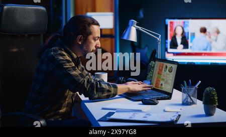 Man concerned about statistical data financial graphs on laptop screen while researching data for company project. Freelancer unhappy about business graphic figures, feeling stressed, camera A Stock Photo