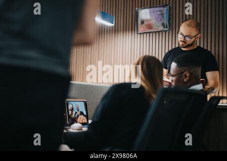 Diverse team of business professionals engaged in a discussion at workplace Stock Photo