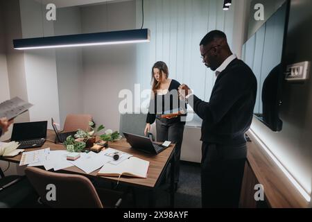 Young multicultural office team collaborating in a modern workspace Stock Photo