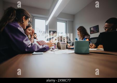 Multicultural team collaborates on a project in a modern office Stock Photo