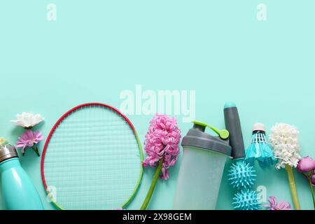 Composition with sports equipment and beautiful flowers on color background Stock Photo