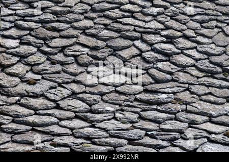 Close-up of an old roof covered with lauzes in Auvergne, France. Lauze, or lause, or lava, is a rock used for roofing in several regions of Europe Stock Photo