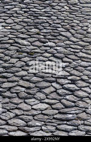 Close-up of an old roof covered with lauzes in Auvergne, France. Lauze, or lause, or lava, is a rock used for roofing in several regions of Europe Stock Photo