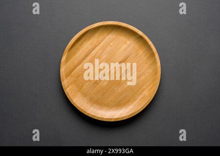 Wooden plate on dark gray background. handmade kitchen utensils Stock Photo