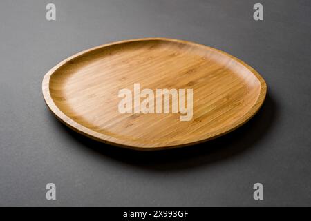 Wooden plate on dark gray background. handmade kitchen utensils Stock Photo