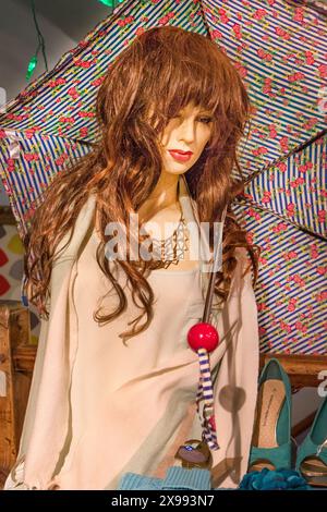 A female fashion mannequin with long  messy hair and full red lips. Stock Photo