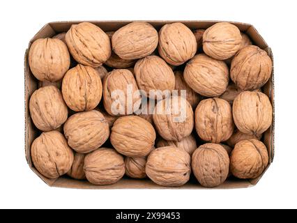 Walnuts in their shells, in a cardboard punnet. Unshelled dried seeds of common walnut tree Juglans regia. Whole nuts with shells, used as snac etc. Stock Photo