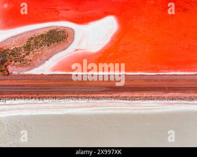 Aerial view of a railway line crossing a vivid red salt Lake Bird at Port Augusta in the Spencer Gul of South Australia Stock Photo