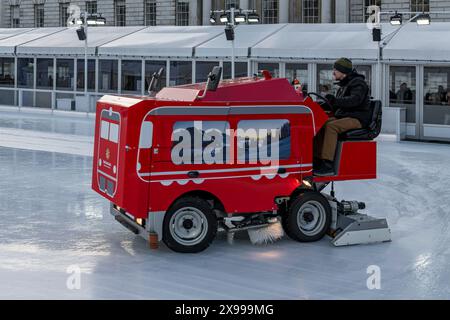 Machine and driver preparing ice rink at Somerset House Stock Photo