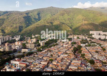 Aerial view of Caracas at sunset with the David Tower landmark skyscraper and slums visible. Drone shot of the venezuelan capital at sunset. Concept o Stock Photo