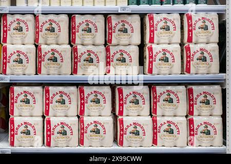 Birra Moretti L'autentica beer on supermarket shelves, Italian brand from 1895, known for traditional brewing methods and high-quality ingredients Stock Photo