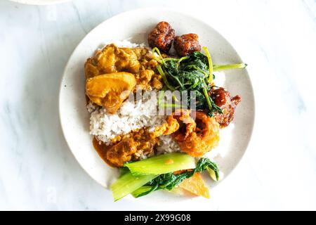 Malaysian Malay and Chinese Buffet Dinner Set with Spinach, Chicken, Rice, Pork Ribs etc. Stock Photo