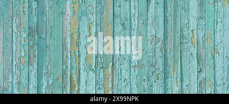Vintage beach background is an old wooden board painted in azure color. Turquoise vintage background with copy space for design. Wide banner. Stock Photo