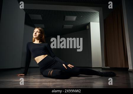 Female choreographer practicing floorwork moves in studio Stock Photo