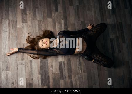 Female dancer practicing floorwork moves in high heels Stock Photo