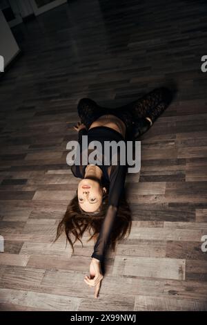 Stiletto dancer is doing floorwork choreography in dance studio Stock Photo