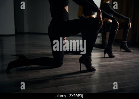 Trio of high heels dancers stretching before dancing Stock Photo